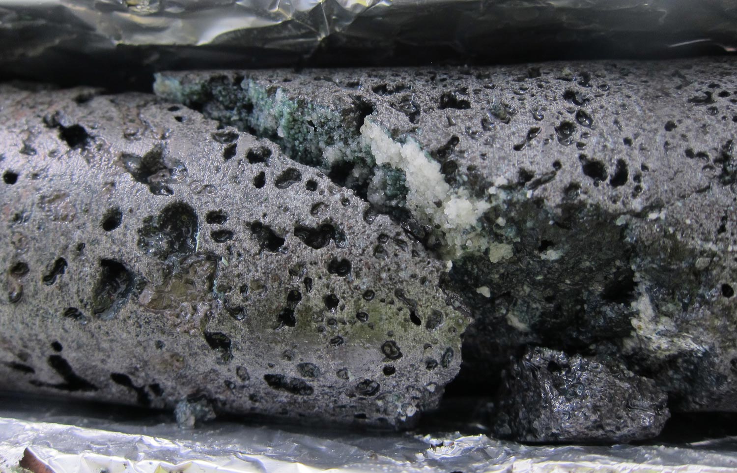 The CarbFix2 project in Iceland injects CO2 in liquid form, rather than as a gas, into porous basaltic rock underground. The CO2 reacts with the rock to form less harmful calcite. Image credit: Sandra O. Snaebjornsdottir, CarbFix